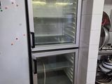 an empty refrigerator in a kitchen with a lot of pots and pans on the counter