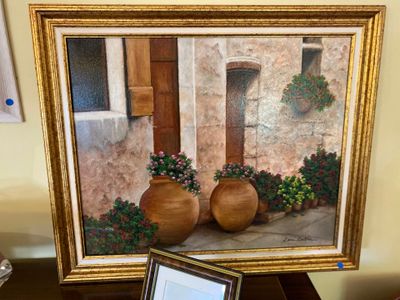 a picture of a painting on a table next to a laptop