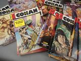 a lot of comic books sitting on a table