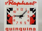 a square clock with a red and black design on it