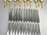 a lot of knives and spoons that are on a table