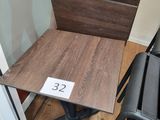 a small table with a number on it next to a stack of chairs