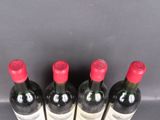 six bottles of wine are lined up in a row on a table