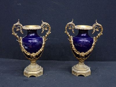 pair of antique blue vases with gold accents on pedestals