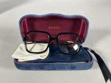 gucci eyeglasses in a case on a white surface