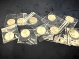 some gold coins are sitting in plastic bags on a black surface