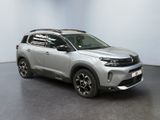 a silver suv parked in front of a white wall
