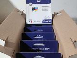 four ink cartridges are in a cardboard box on a table