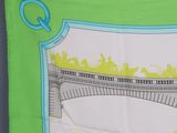 a green scarf with a picture of a train on it