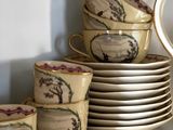 many cups and saucers stacked on top of each other