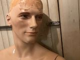 a mannequin of a man with a tattoo on his chest