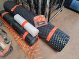 a roll of black and orange construction material on the floor