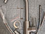 a faucet that is sitting on the floor next to a hose