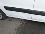 a white van with a black stripe parked in a parking lot