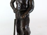 bronze statue of a man with a baseball bat on a log