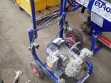 an image of a blue and white machine on the ground