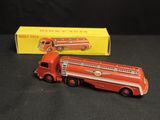 a red toy fire truck with a box on the table