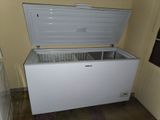 a white chest freezer sitting in the corner of a room