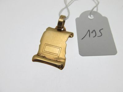 a gold plated necklace with a small piece of paper attached to it
