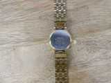 a watch that is sitting on a wooden table