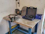 a workbench in a garage with tools on it