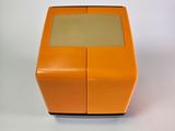 an orange box with a glass top sitting on a white surface