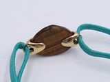 bracelet with a brown stone on a green cord