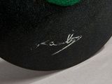 a close up of a green hat on a table