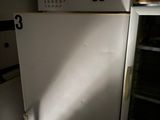 a white refrigerator in a dark room with the door open