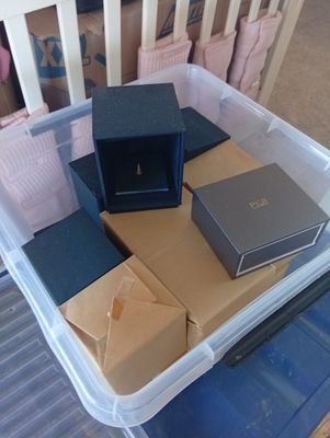 a plastic container filled with boxes on top of a table