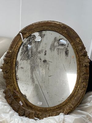 a mirror that is sitting on a bed in a room