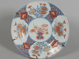 a blue and white plate with orange flowers on it