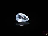 a close up of a white diamond on a black surface