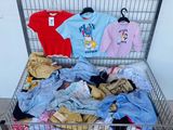 a metal cart filled with clothes and clothing items