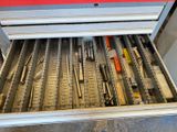 a drawer full of pens and pencils on the floor