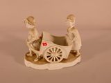 a figurine of a man and a woman in a carriage