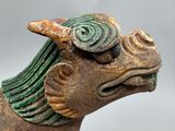 a close up of a statue of a horse with a bird on it ' s head