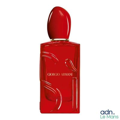 a close up of a bottle of perfume on a white background