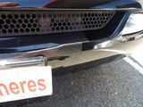 a close up of a car with a sign on the front of it