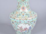 a blue vase with a picture of a bird on it
