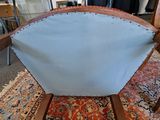 a chair with a blue cushion on it in a room
