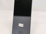 the back of a black cell phone sitting on top of a table