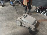 a man that is pushing a cart with a lot of bottles