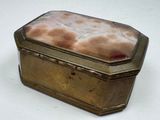 a silver box with a piece of bread inside of it