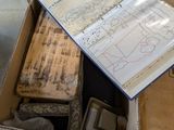 a box full of old books on the floor