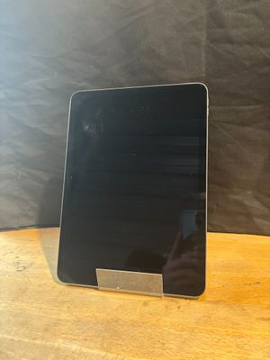 a tablet computer sitting on top of a wooden table