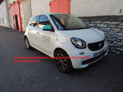 smart car parked in front of a building with a red door