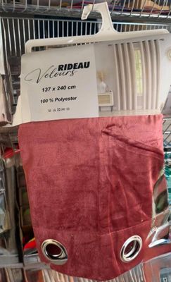 a red towel hanging on a rack in a store