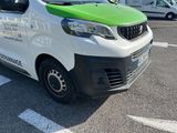 a white and green van parked on the side of the road