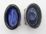 pair of silver and blue glass bowls on a white surface